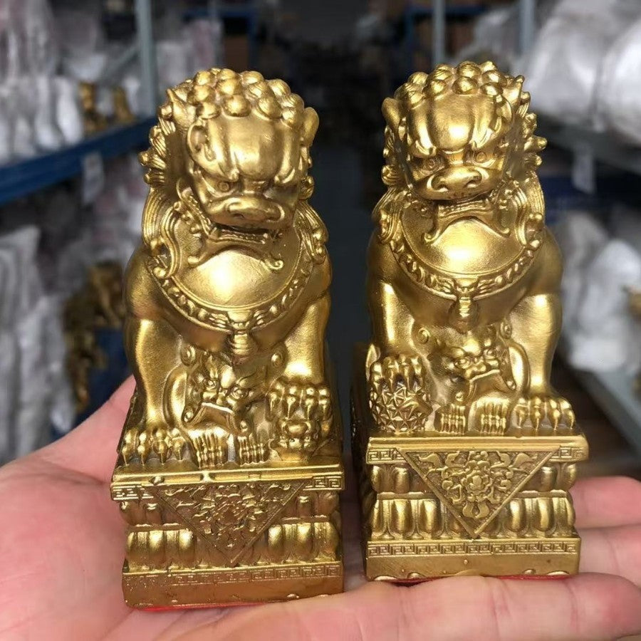 Yellow brass Chinese palace guardian lion pair with cub and ball motifs on ornate lotus-style bases, traditional entrance decor