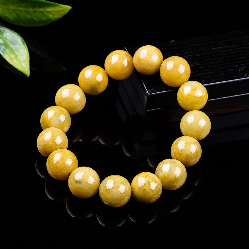 Polished honey yellow jadeite beads showing natural colour variation