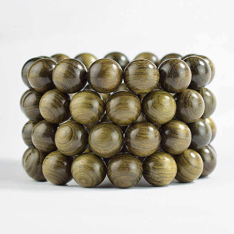 Stacked Yinchen golden-thread wood bracelets showing multiple bead sizes