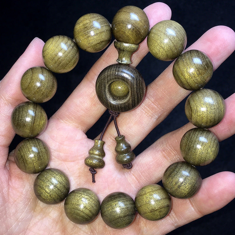 Yinchen wood turning-wheel and gourd bracelet shown in hand