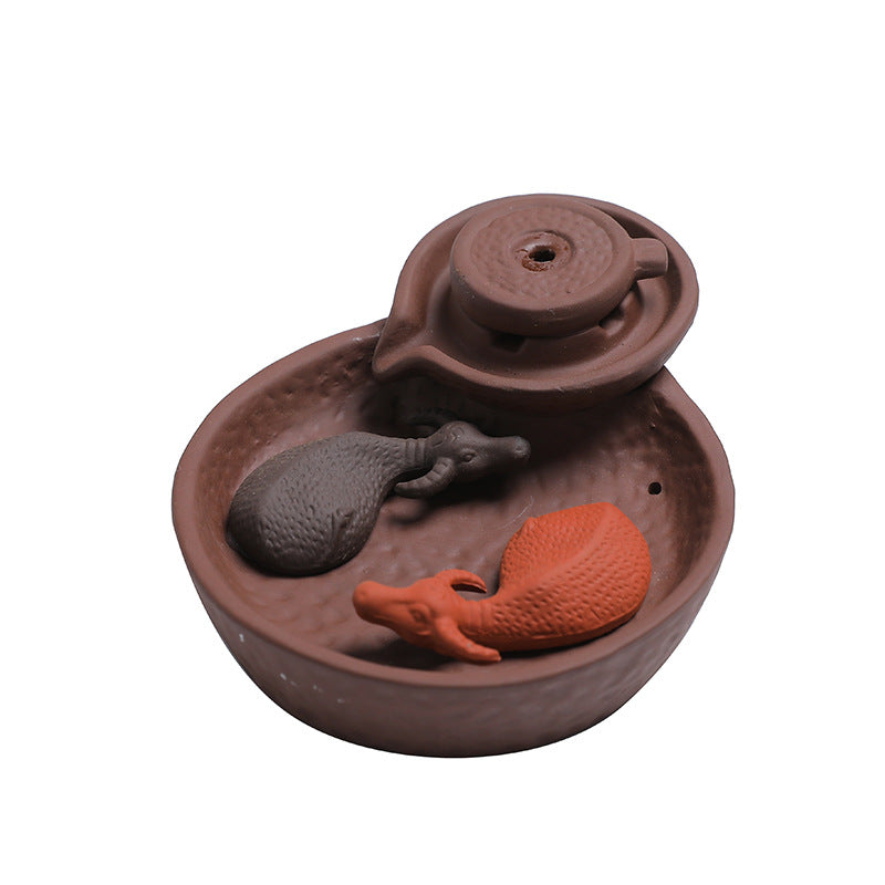 Compact purple clay yin yang mice incense burner on white background
