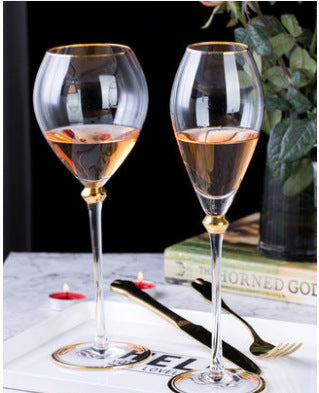 Clear stemmed wine goblets styled with the black and gold tableware collection