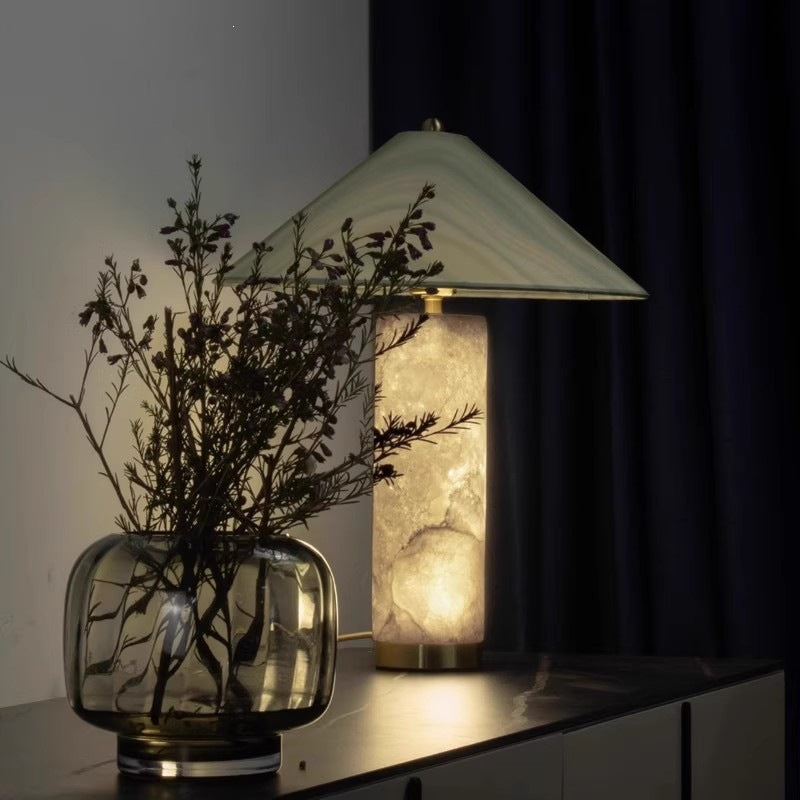 Green veined cone shade cloud-stone table lamp beside books and floral arrangement