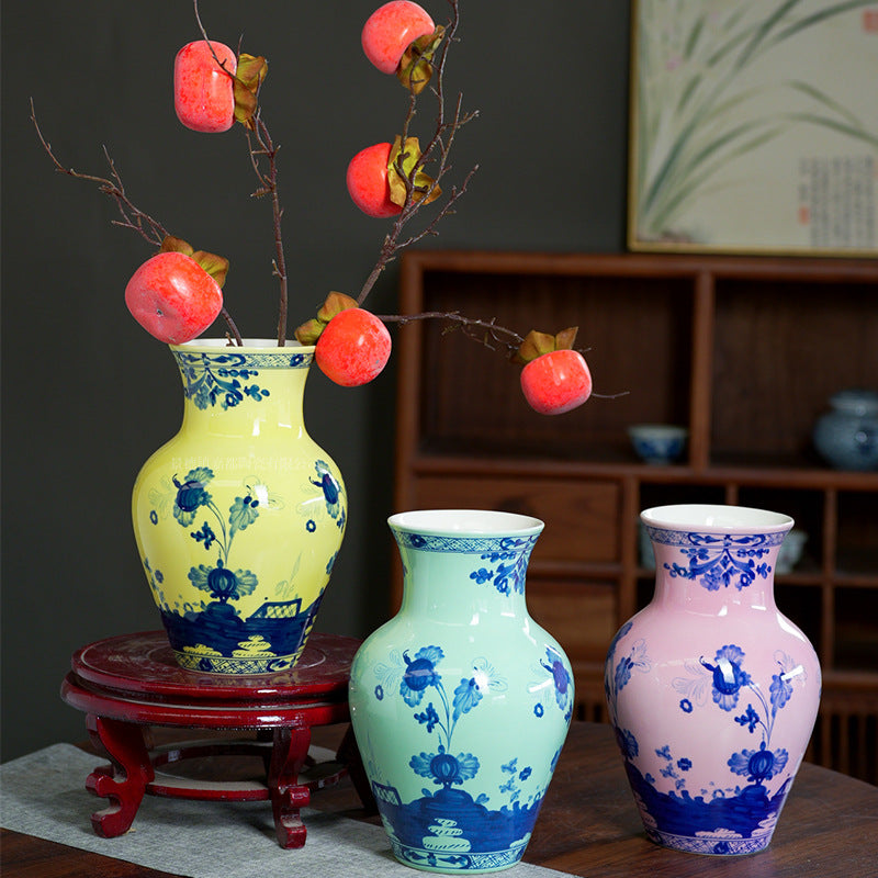 Yellow, celadon green and blush pink floral ceramic vases styled with lantern branches