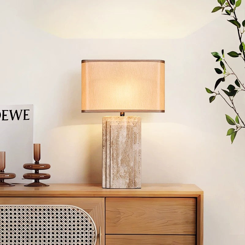 Cream travertine rectangular table lamp styled on a wood sideboard