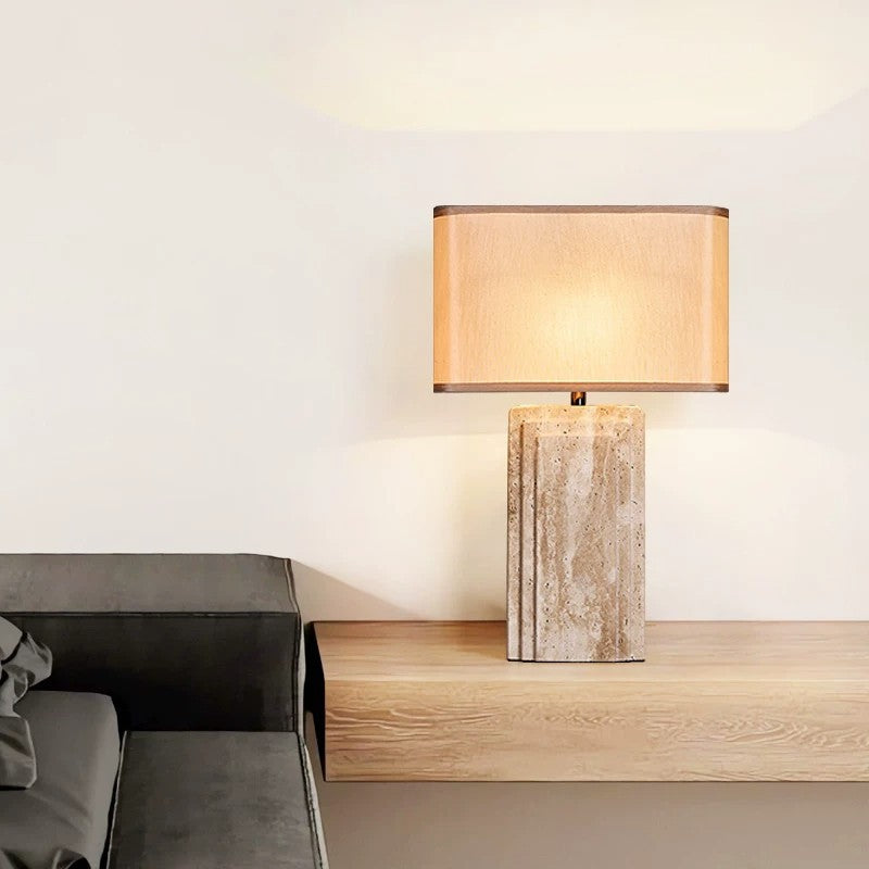 Cream travertine column table lamp in a minimalist interior