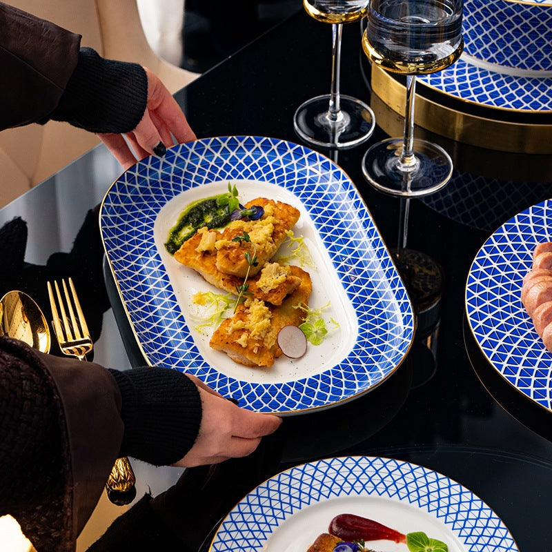 Dongli Youran blue lattice serving platter styled on a black and gold table