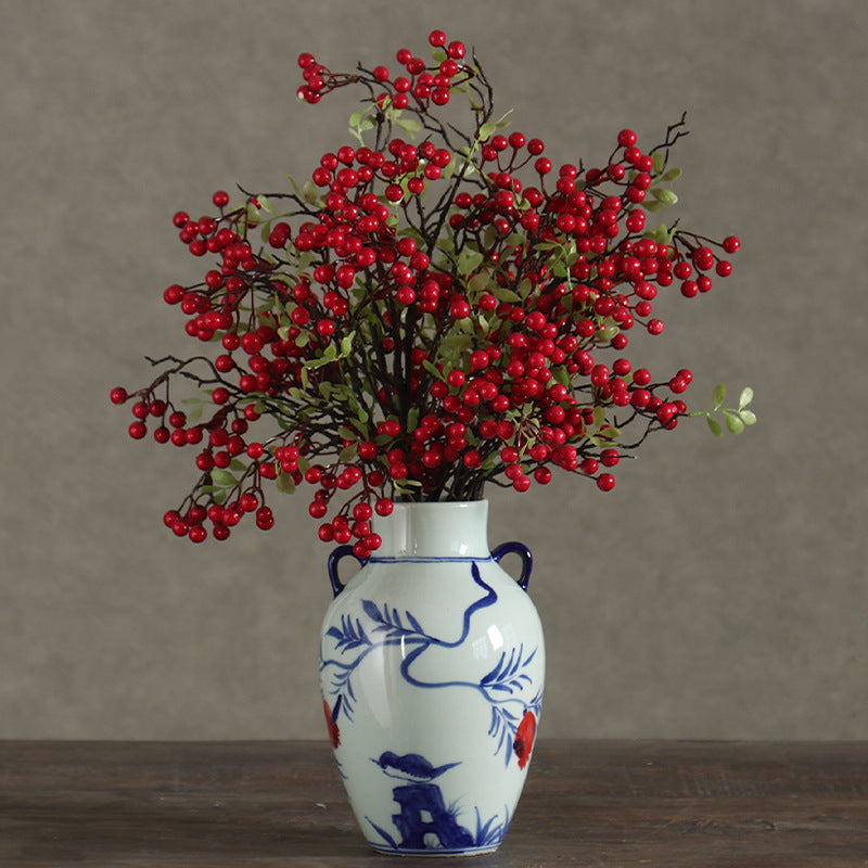 Blue and white double-ear pomegranate vase styled with red berry branches