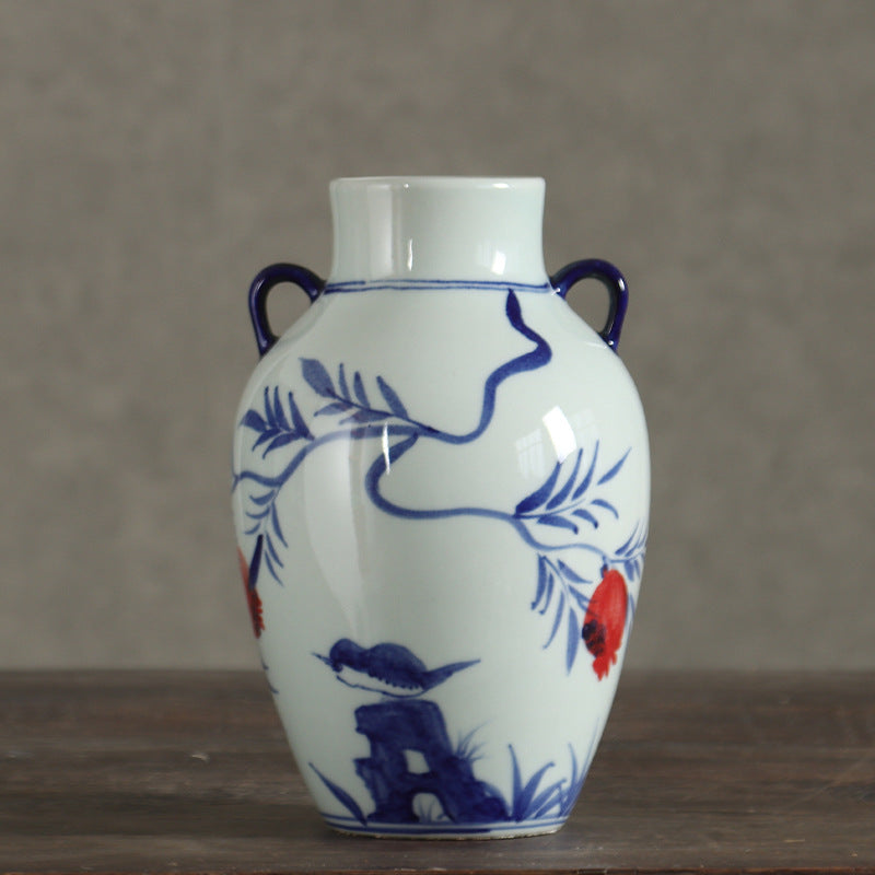 Blue and white small bird pomegranate vase styled on dark wood