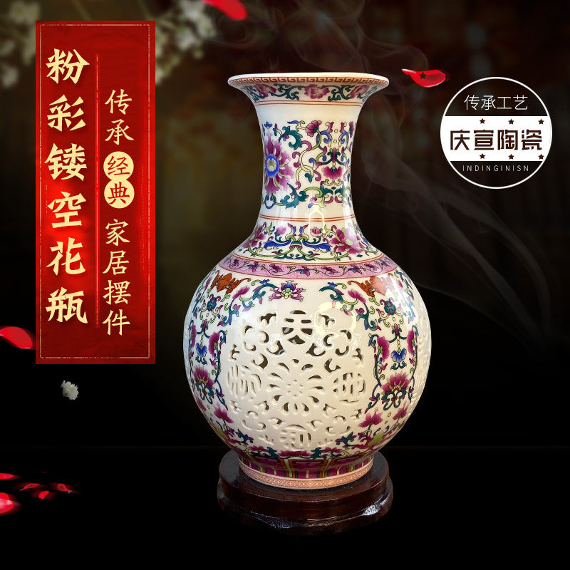 Famille rose openwork porcelain vase displayed against black background