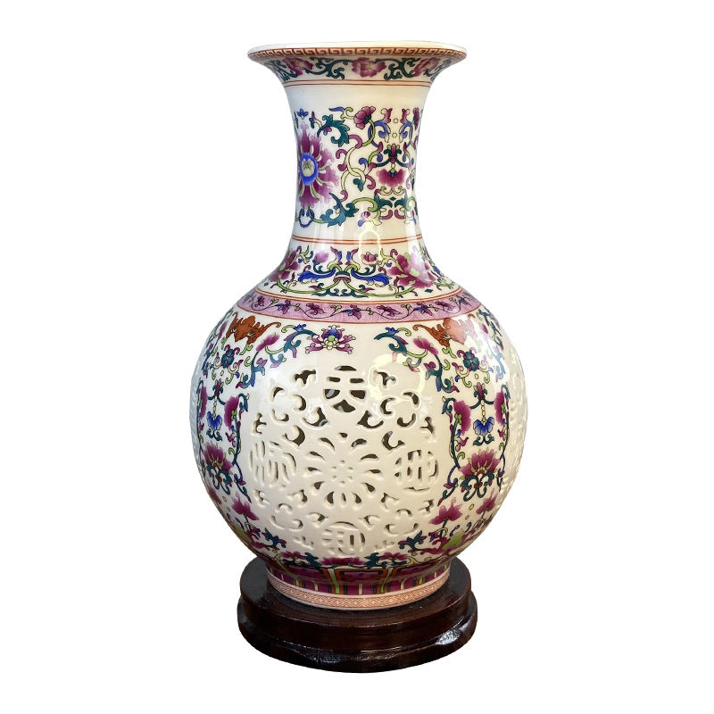 Famille rose openwork Chinese porcelain vase on white background