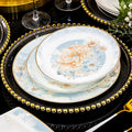 Fan Hua Ying Xue pale blue, ivory and gold floral dinnerware layered on a luxury table setting