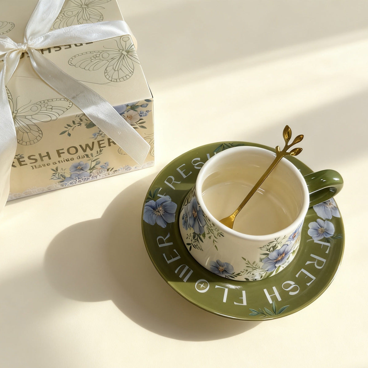 Olive green floral ceramic coffee cup and saucer with painterly blue and pink flowers