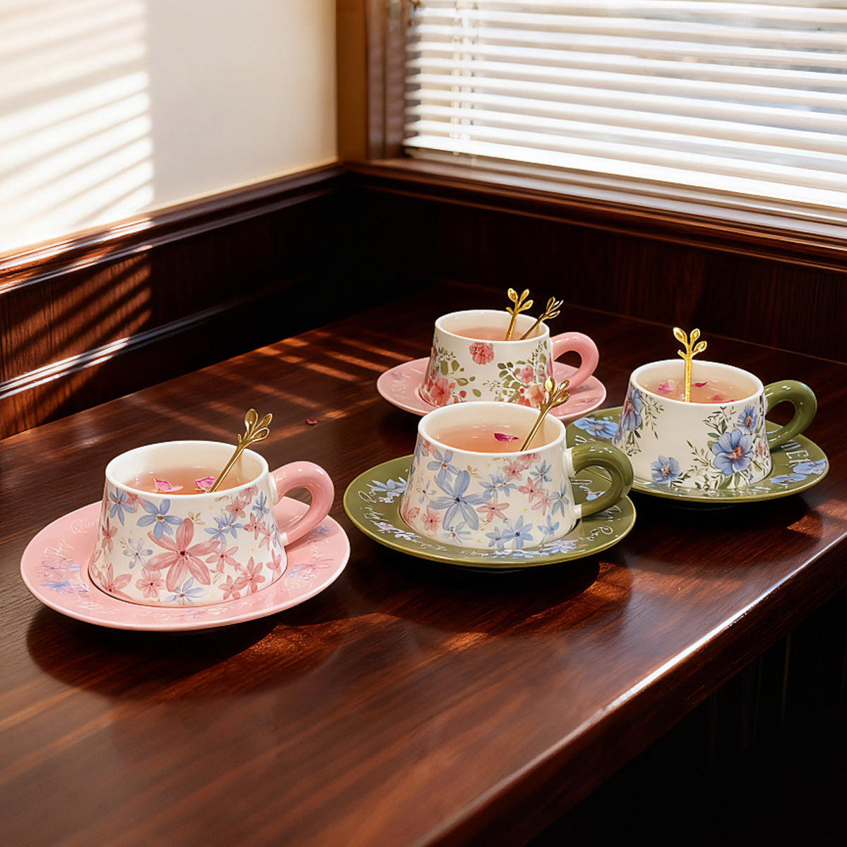 Pink and green botanical ceramic coffee cups with matching saucers and floral gift-box styling