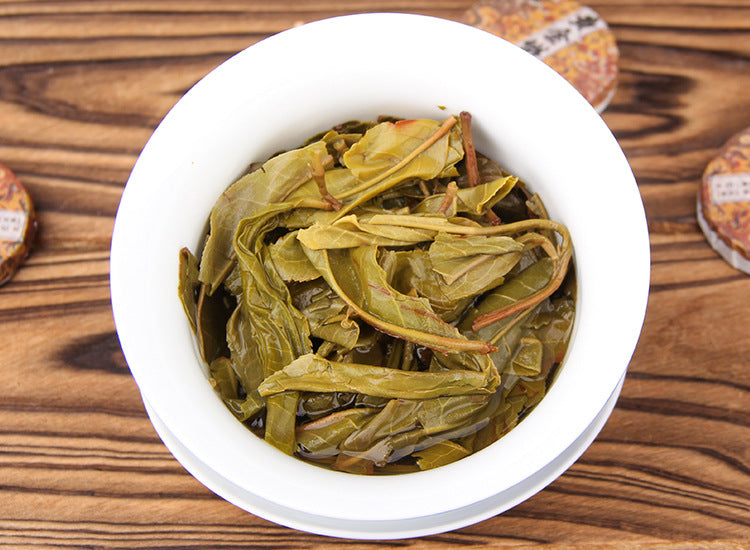 Golden Leaf raw Pu-erh mini tea cakes stacked for daily Gongfu brewing