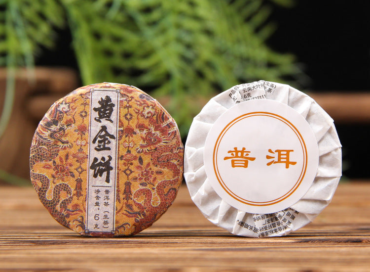 Brewed Golden Leaf raw Pu-erh mini cake with clear golden tea liquor