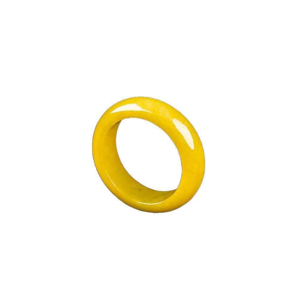 Natural yellow jadeite ring band close-up showing glossy polish and warm golden tone