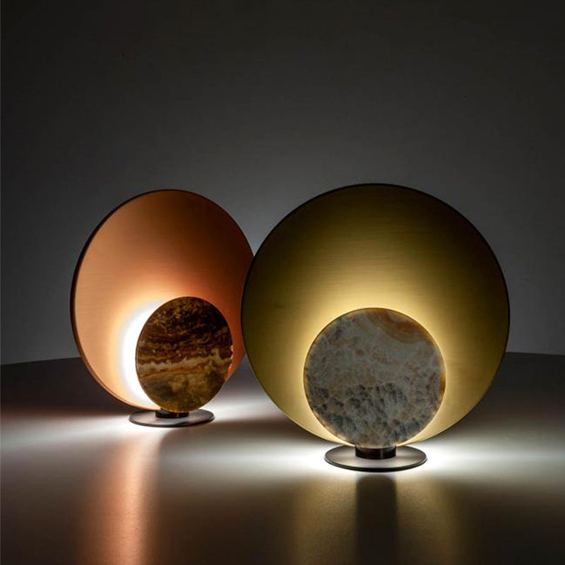 Gold and rose-gold disc lamps glowing in a modern interior