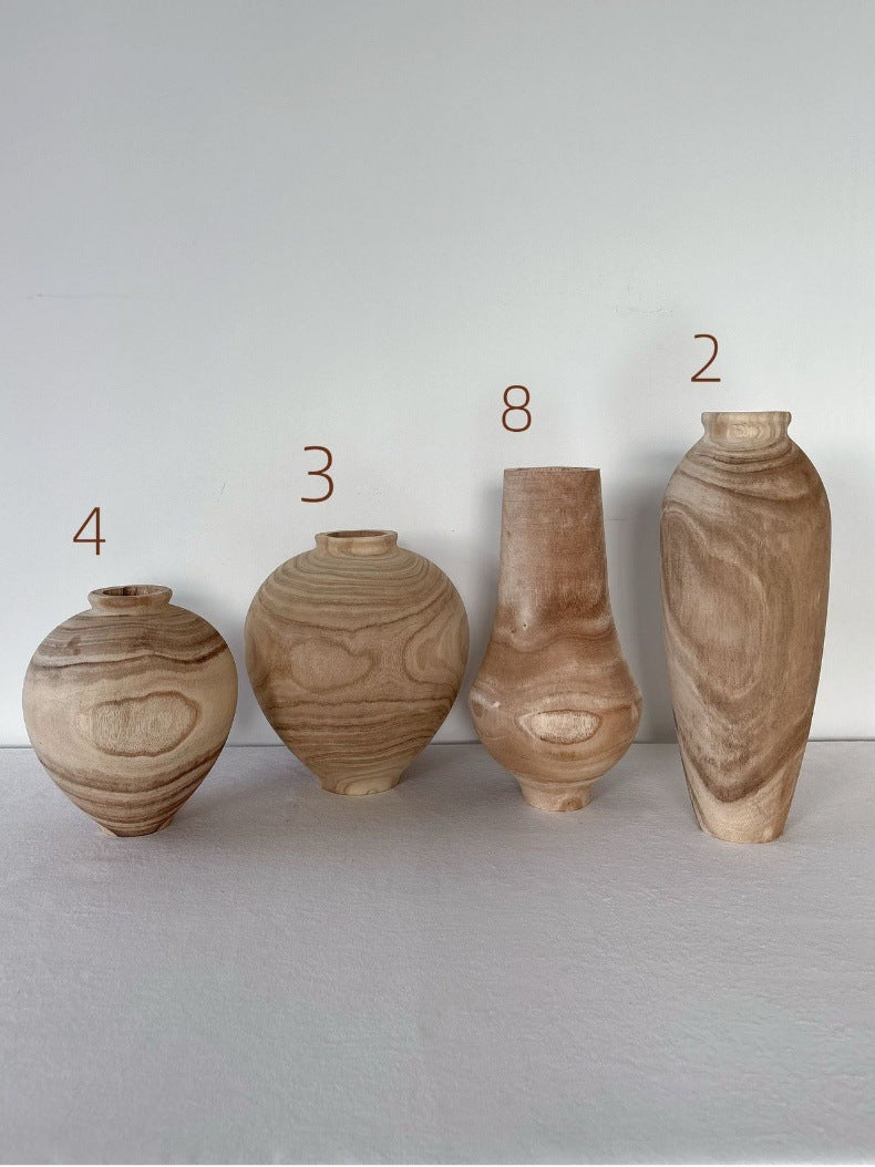 Natural solid wood decorative vases showing four hand-carved sculptural forms