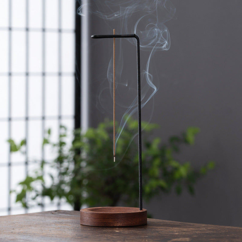 Minimalist hanging incense stick stand with walnut wood base and black metal arm