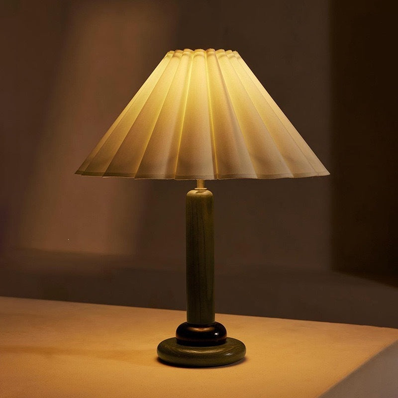 Olive green wood table lamp with wide pleated cream fabric shade