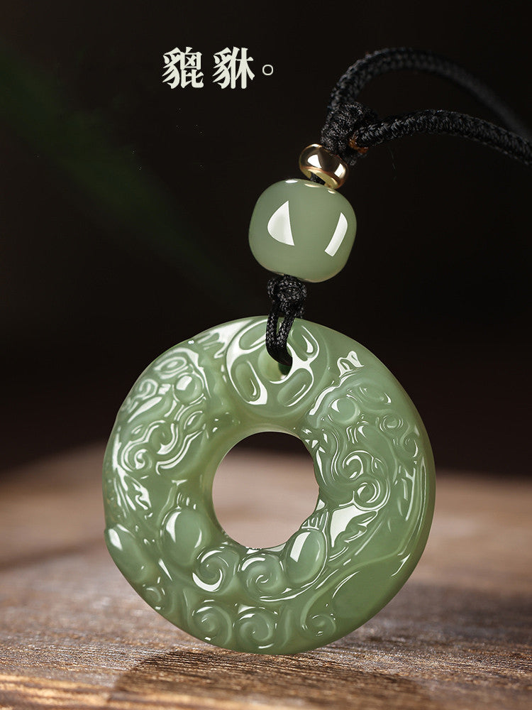 Lake green Hetian jade pendant with carved double Pixiu motif and braided cord