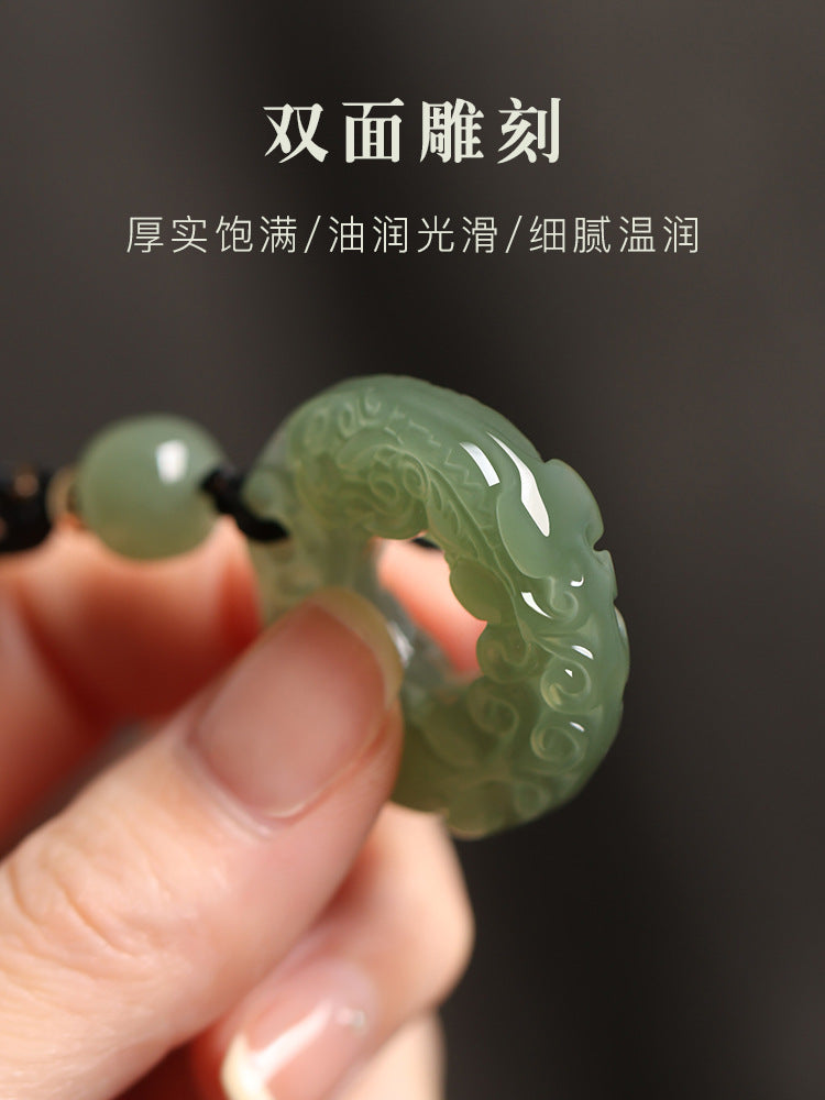 Natural Hetian jade Pixiu pendant, polished carved round amulet close-up