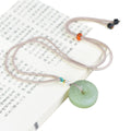 Certified natural Hetian jade lotus peace buckle pendant in clear lake green