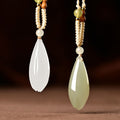 Qing Shui green and white Hetian jade magnolia pendants side by side