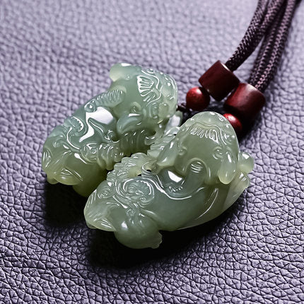Xinjiang Hetian jade Pixiu carving with green bead strand and red accent