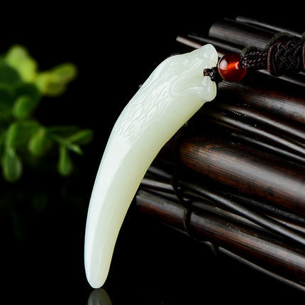 Natural Xinjiang Hetian jade wolf fang pendant with braided cord and red bead
