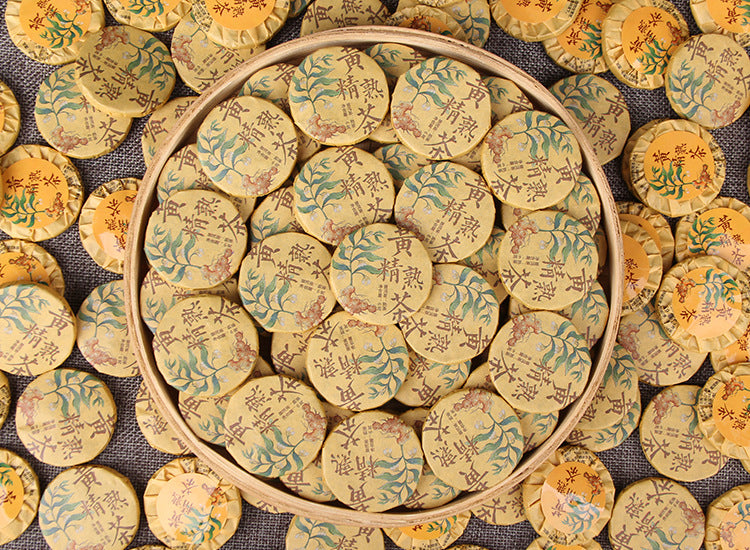 Huangjing ripe Pu-erh mini cakes arranged in a bamboo tray