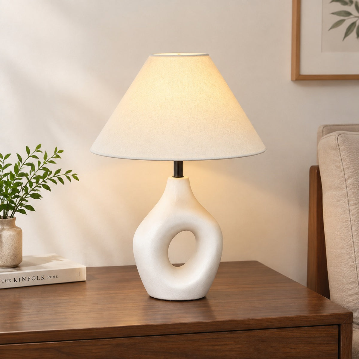 Ivory ceramic ring table lamp in a warm minimalist bedroom