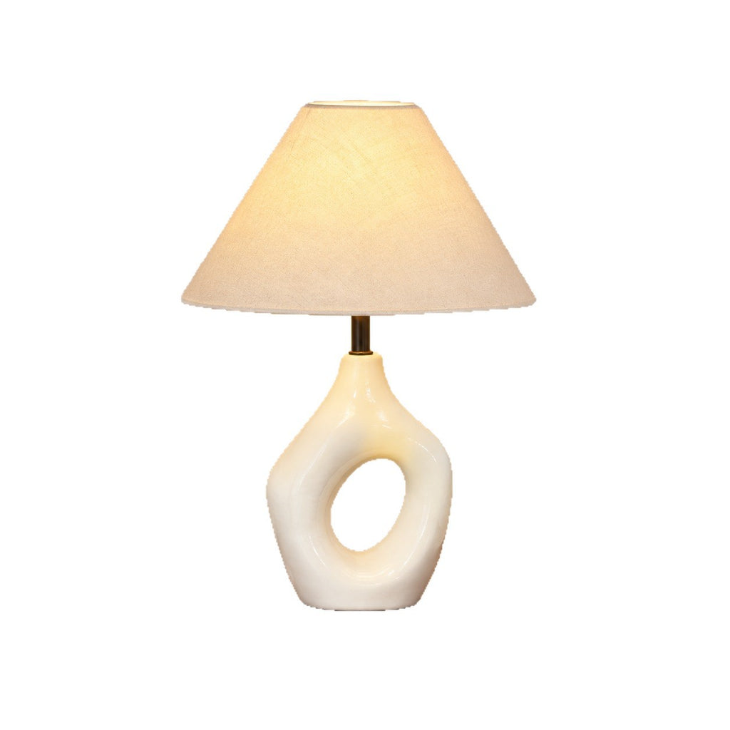 Ivory white sculptural hollow ring ceramic lamp on white background