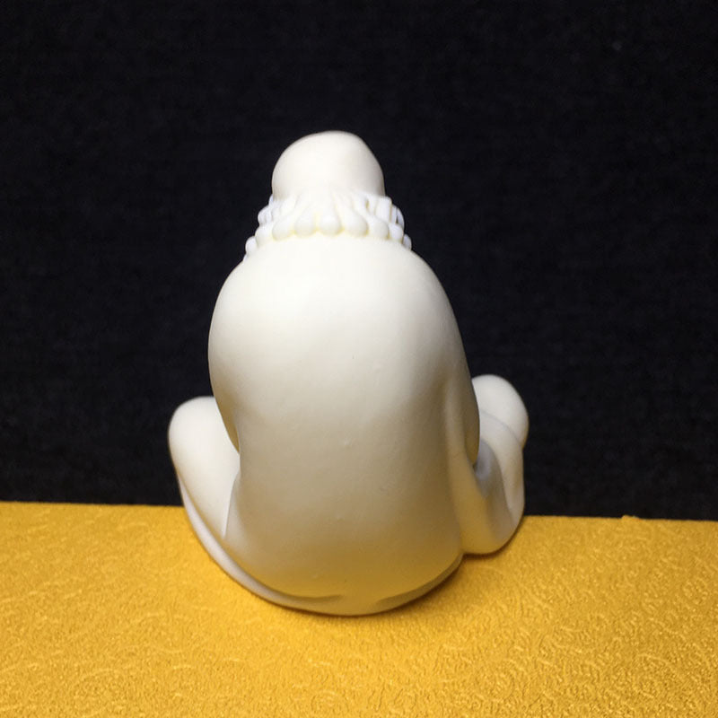 Back view of carved ivory nut Bodhidharma monk ornament in natural tagua vegetable ivory