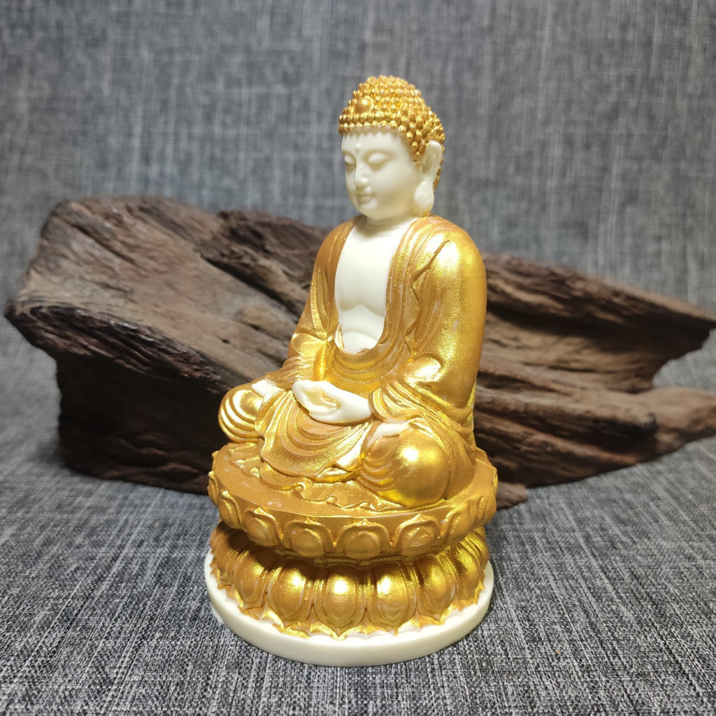 Side view gold-accented tagua Shakyamuni Buddha seated on lotus throne, vegetable ivory spiritual decor
