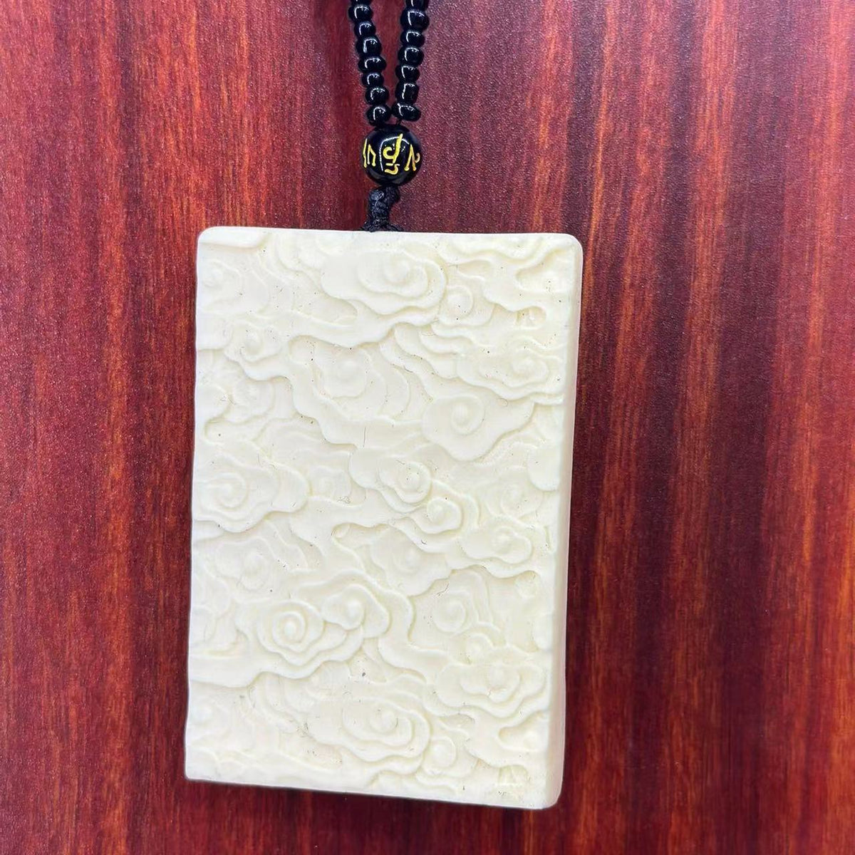 Back view ivory nut Dainichi Nyorai Vairocana pendant with carved cloud pattern, tagua vegetable ivory Buddhist hanging ornament