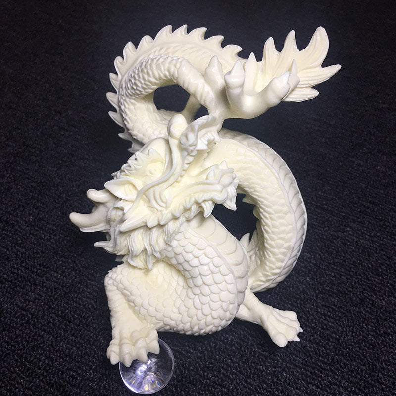 Detailed Chinese dragon carving in tagua vegetable ivory with gold accents for living room and office display