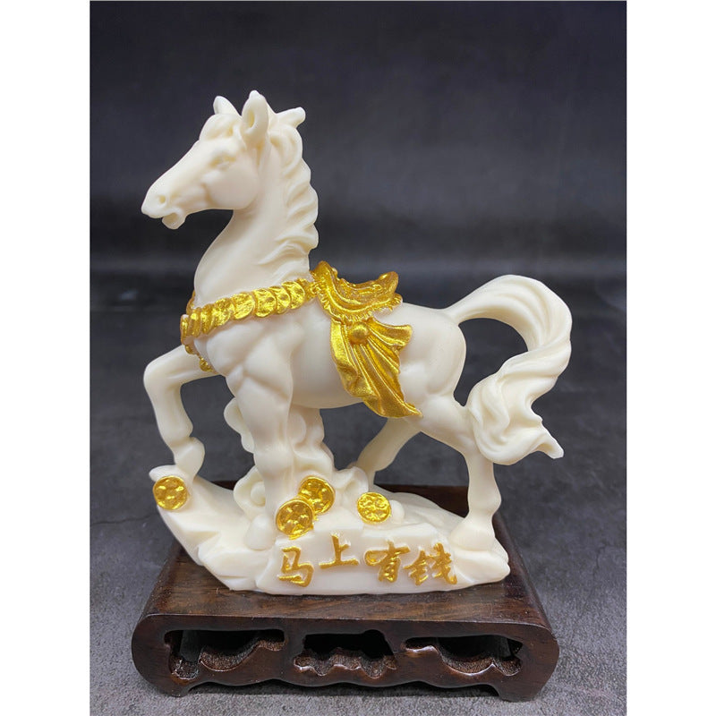 Ivory nut tagua horse ornament with gold accents and Chinese good fortune motif on display stand