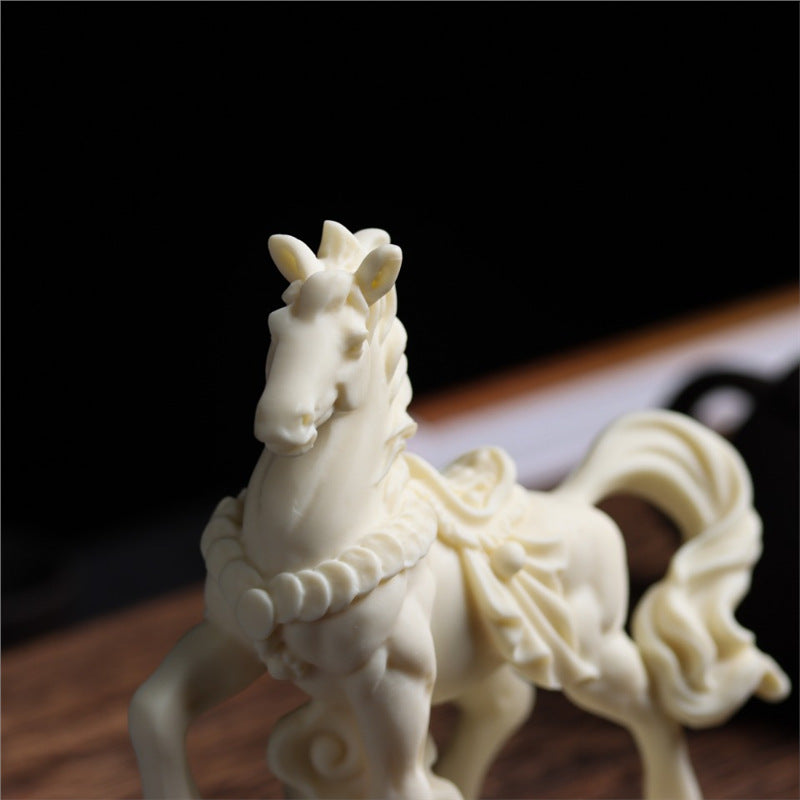 Detailed angle of carved vegetable ivory horse figurine with traditional Chinese decorative styling