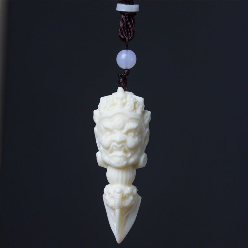 Ivory nut Jiangmo Chu ritual-dagger-inspired pendant with wrathful multi-faced carving, tagua vegetable ivory Chinese cultural hanging ornament