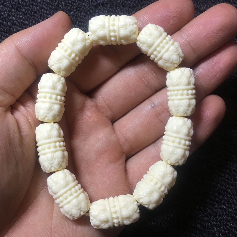 Ivory nut lotus barrel bead bracelet shown in hand for scale, tagua vegetable ivory carved bracelet with large lotus barrel beads