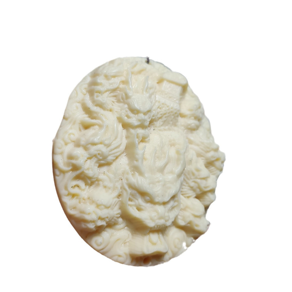 Ivory nut Nine Dragons and Ancient Coffin fantasy pendant front view, tagua vegetable ivory high-relief Chinese dragon carving