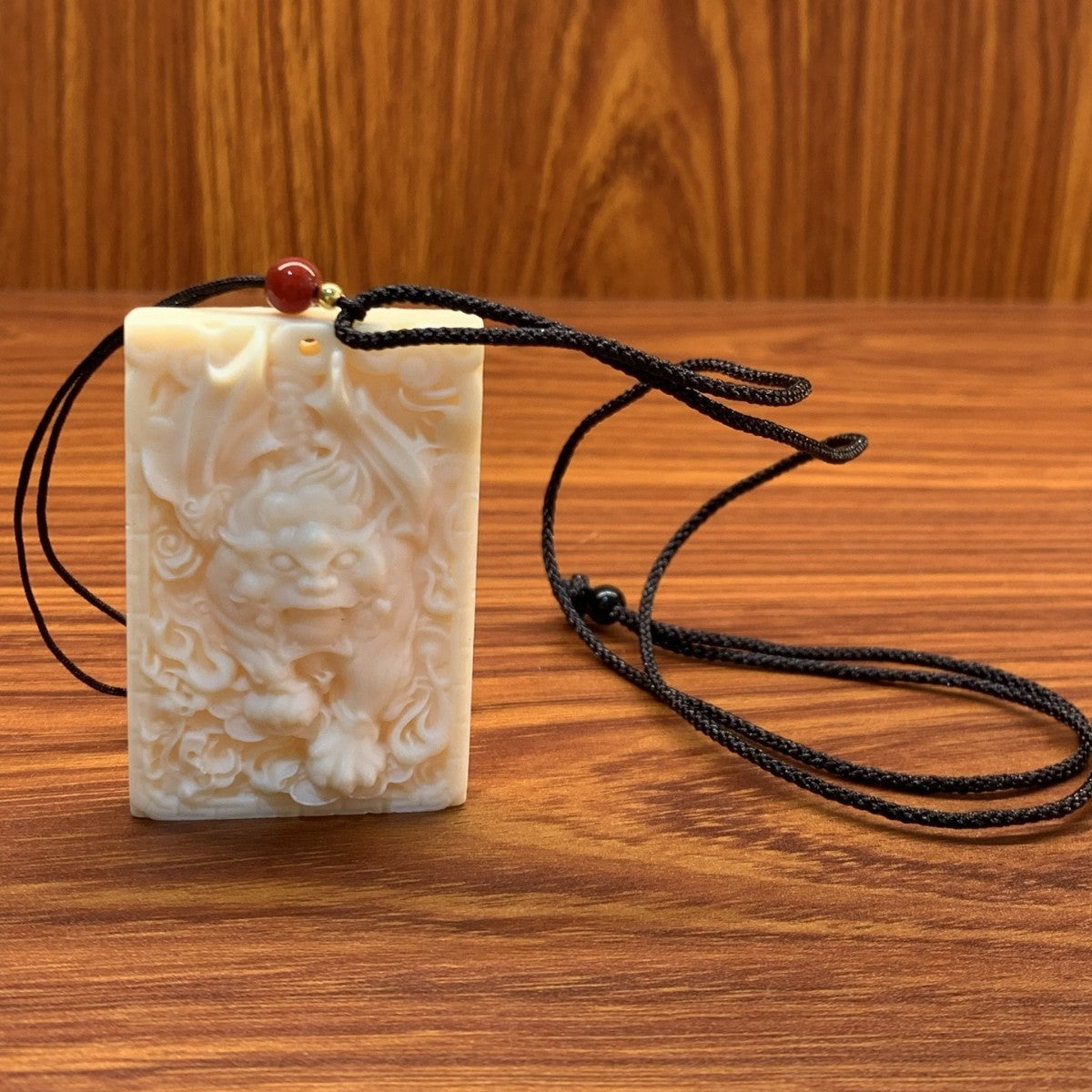Ivory nut Pixiu plaque pendant with black cord, tagua vegetable ivory Chinese auspicious relief carving approximately 3.7 × 1 × 5.5 cm