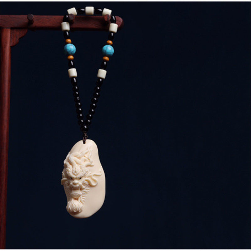 Ivory nut Soaring Dragon relief carving with bead cord, tagua vegetable ivory Chinese dragon handpiece and hanging pendant