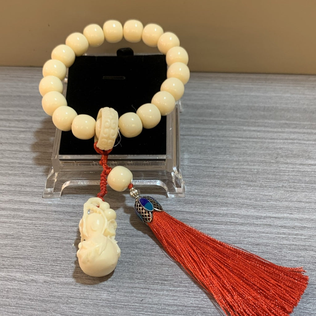 Chinese ivory nut bracelet with creamy tagua beads, carved pendant and red tassel for meaningful gift
