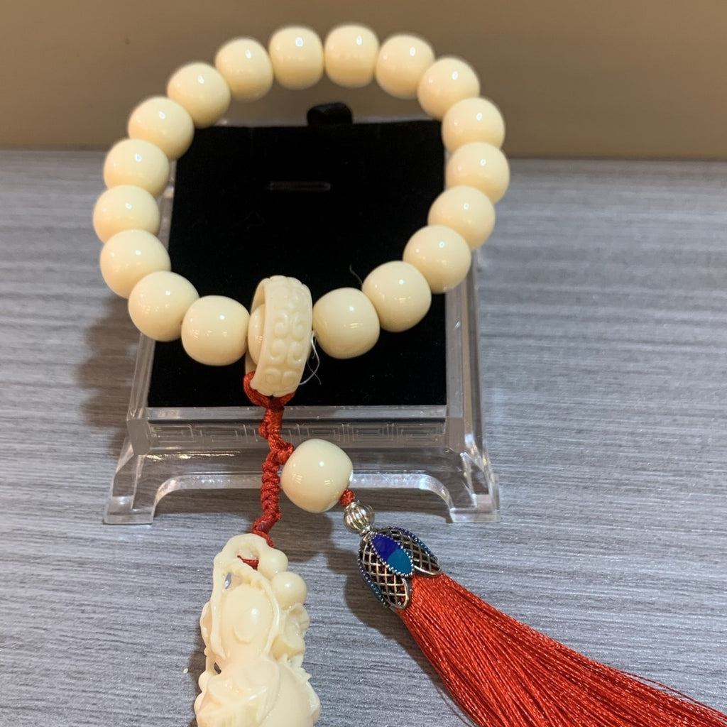Hand-finished vegetable ivory tagua bead bracelet with traditional Chinese red cord and tassel detail