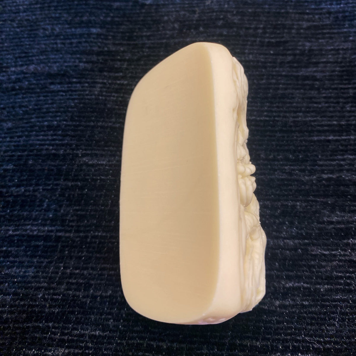 Detailed ivory nut Taotie dragon beast carving with fangs and coiled dragon form, tagua vegetable ivory Chinese pendant