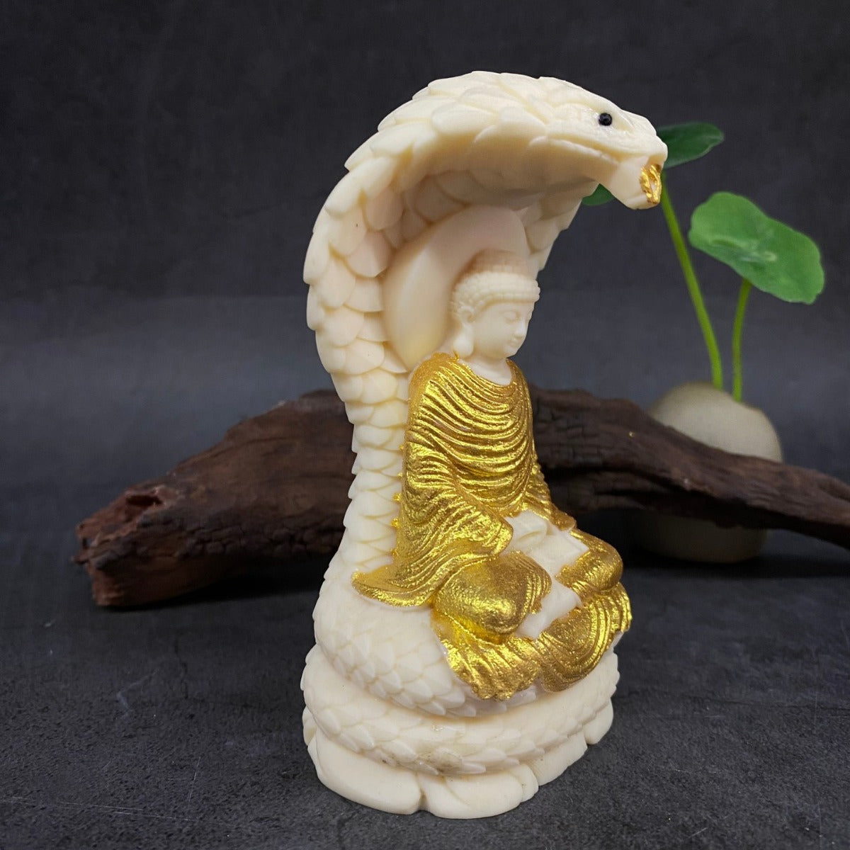 Detailed vegetable ivory cobra Buddha carving with lotus seat and serpent canopy for symbolic home display