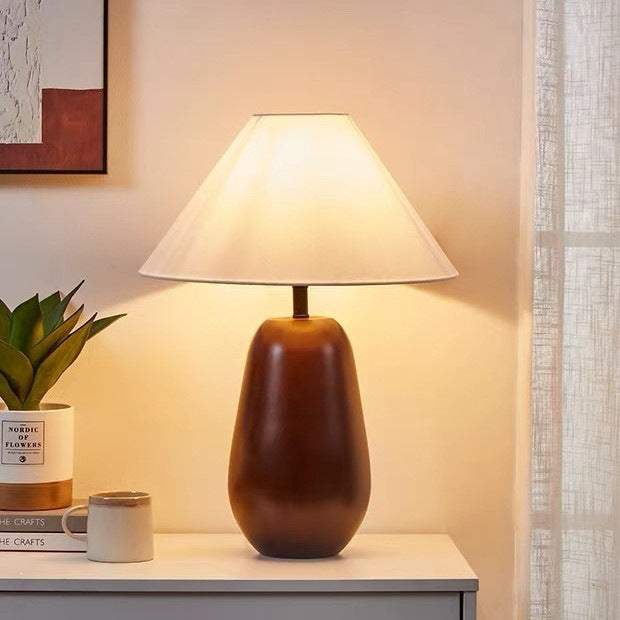 Warm brown solid wood bedside lamp with soft cream fabric shade